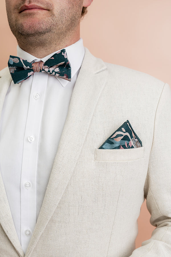 Elegant bow tie with an intricate Teal Blooms design, showcasing a deep teal background enhanced by bright pink and white floral accents, perfect for making a bold statement at special events
