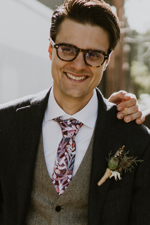 Groom in the stylish cotton tie showcasing a vibrant protea design in burgundy, ideal for formal occasions and nature lovers